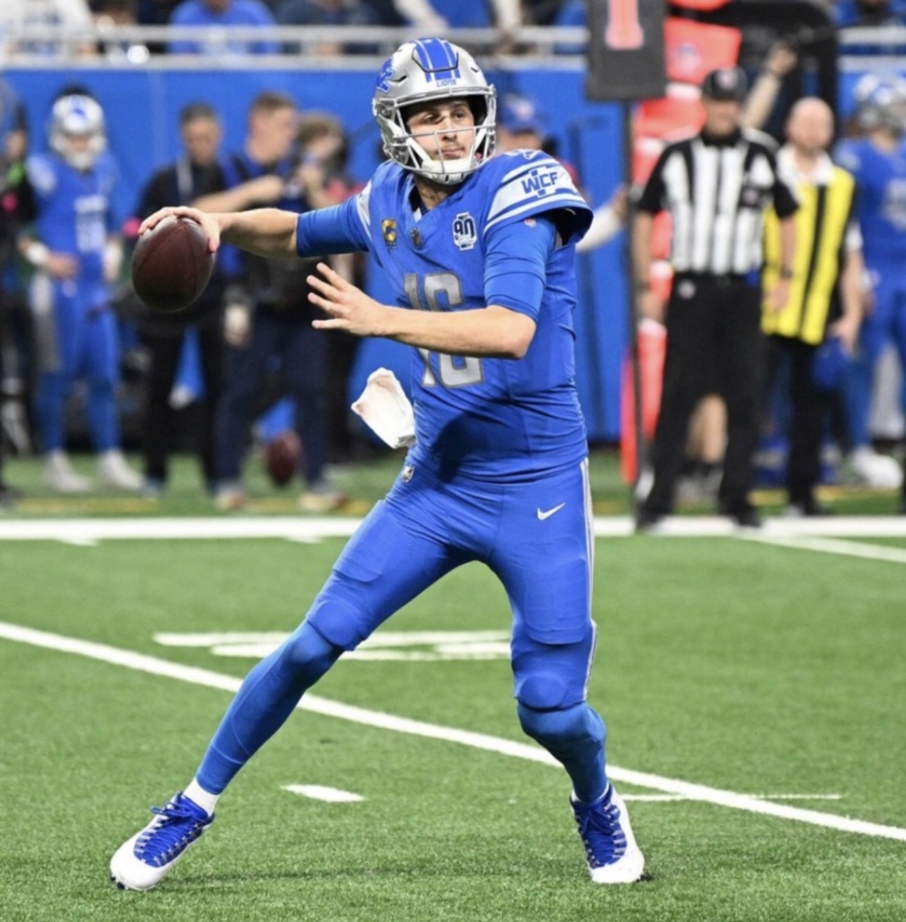 Detroit Lions player getting ready to throw a football